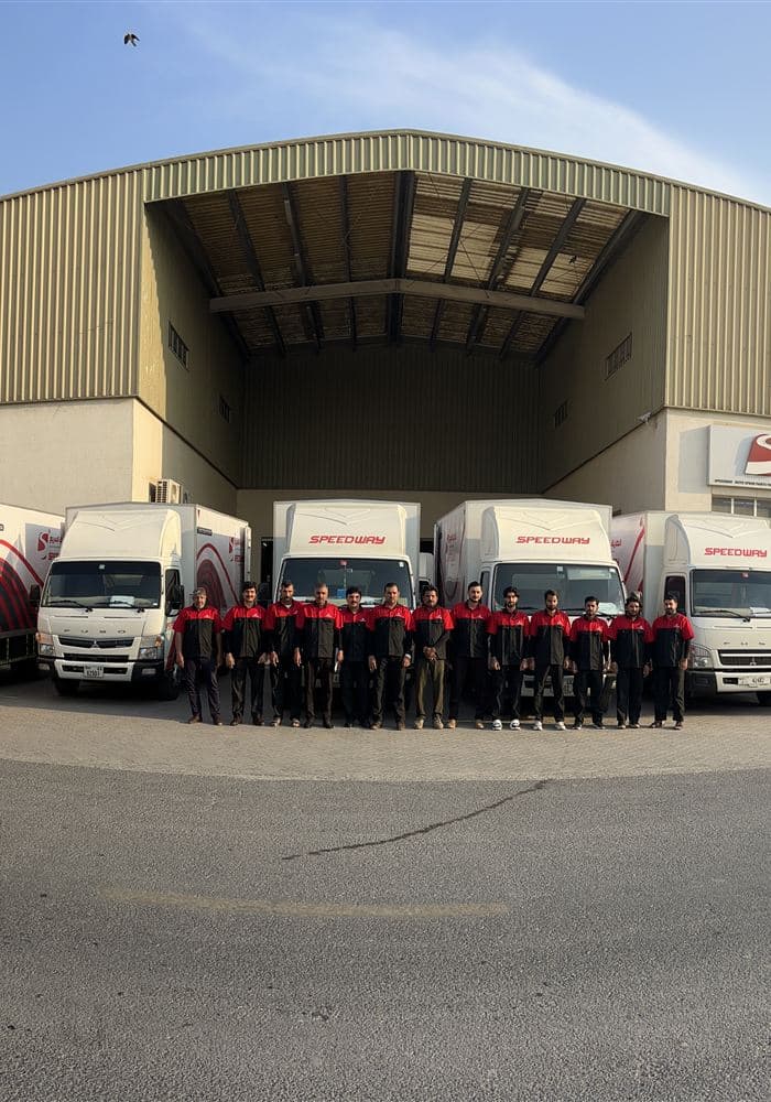 Speedway team in uniform with delivery fleet